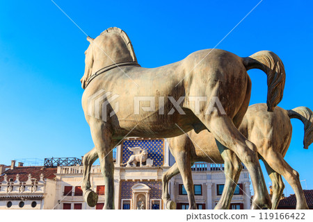 Horses of Saint Mark, also known as the Triumphal Quadriga or Horses of the Hippodrome of Constantinople, and Clock Tower at San Marco Square in Venice, Italy 119166422