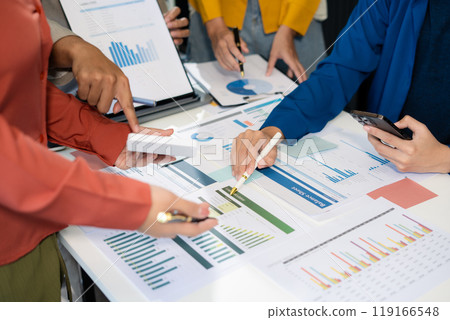 Marketing staff are analyzing the data to business planning at office. Marketing staff are analyzing the data to business planning at office. 119166548