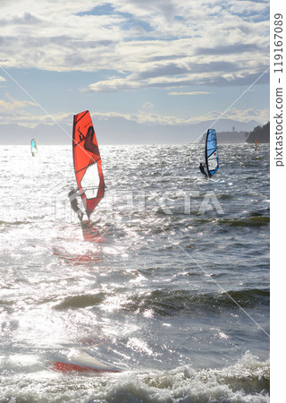 A surfer windsurfing in rough seas due to strong winds A surfer windsurfing in rough seas due to strong winds 119167089
