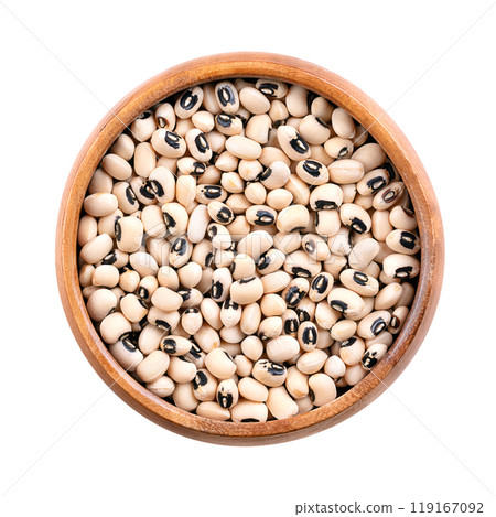 Dried black eyed peas in a wooden bowl. Also black eyed beans, or California blackeye, a legume of medium-sized beans, pale-colored with prominent black spot. Subspecies of cowpeas, Vigna unguiculata. Dried black eyed peas in a wooden bowl. Also black eyed beans, or California blackeye, a legume of medium-sized beans, pale-colored with prominent black spot. Subspecies of cowpeas, Vigna unguiculata. 119167092
