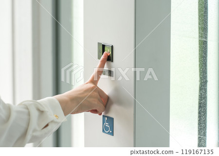 Woman pressing the elevator button Woman pressing the elevator button 119167135