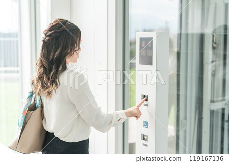 Business woman pushing button of elevator 119167136