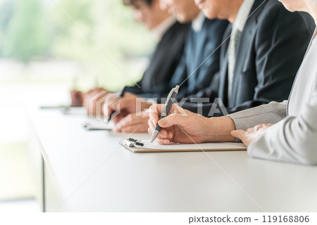 Men and women in suits attending seminars and training sessions 119168806