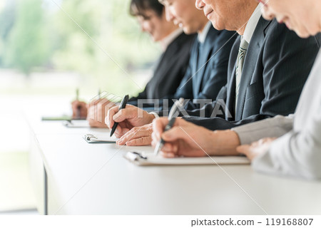 Men and women in suits attending seminars and training sessions Men and women in suits attending seminars and training sessions 119168807