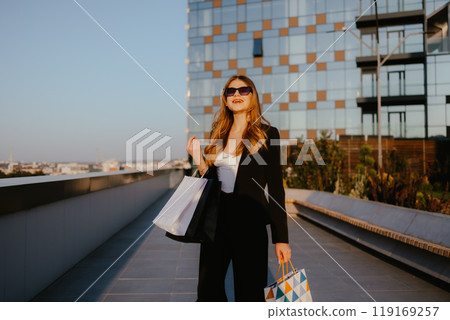 Woman Shopping Outdoors with Modern Building Background 119169257