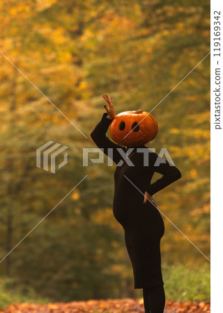 Surreal Autumn Scene with Pumpkin Head 119169342