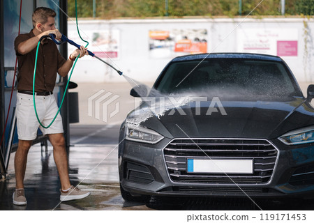 Car washing. Man using high pressure wax for shining. Last process Car washing. Man using high pressure wax for shining. Last process 119171453