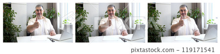 Smiling Man at Desk Giving Thumbs Up Smiling Man at Desk Giving Thumbs Up 119171541