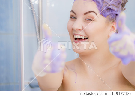 Woman applying toner shampoo on her hair 119172182