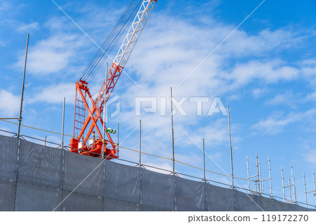 Crane and scaffolding at a construction site 119172270