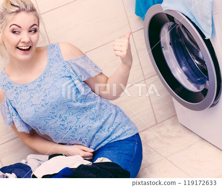 Happy woman washing laundry. Happy woman washing laundry. 119172633