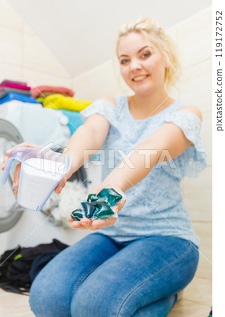 Girl wash laundry with different detergent. 119172752