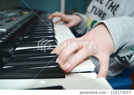 Close up of happy woman's hand playing the piano in the morning. Close up of happy woman's hand playing the piano in the morning. 119173057