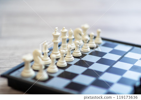 Closeup of a chess board with white and black pieces 119173636