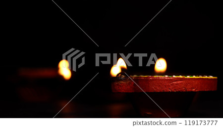 Illuminated Diwali diyas on the floor on dark background. Illuminated Diwali diyas on the floor on dark background. 119173777