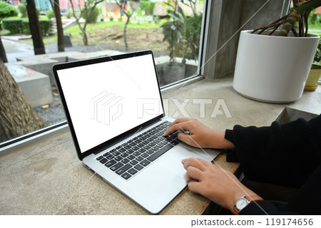 Cropped shot of young woman freelancer working with laptop at cafe 119174656