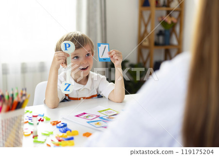 Boy learning letters in classroom setting Boy learning letters in classroom setting 119175204