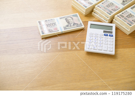 A stack of bills and a calculator on a desk (new bill version) 119175280