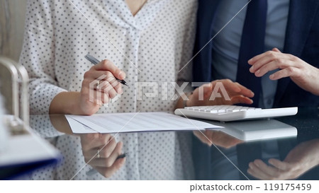 Businesspeople in a meeting with calculator. Sexual harassment is strictly prohibited in the workplace Businesspeople in a meeting with calculator. Sexual harassment is strictly prohibited in the workplace 119175459