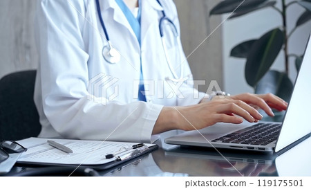 Doctor woman is using laptop computer in clinic office while sitting at the glass desk. Medicine concept Doctor woman is using laptop computer in clinic office while sitting at the glass desk. Medicine concept 119175501
