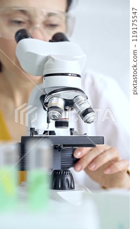 Woman scientist using microscope in laboratory. Microbiology science concept Woman scientist using microscope in laboratory. Microbiology science concept 119175547