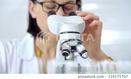 Woman scientist using microscope in laboratory. Microbiology science concept Woman scientist using microscope in laboratory. Microbiology science concept 119175707
