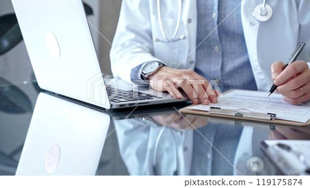 Doctor writing medical records on a glass desk with laptop. Medicine and Health Care 119175874