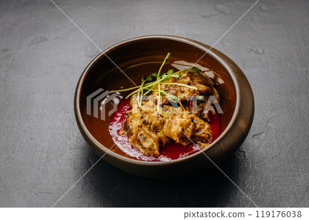 Slow-cooked meat stew served in bowl with sauce and fresh herbs. Ideal for stock food photography 119176038
