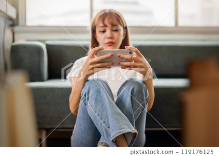 Woman using a smartphone 119176125