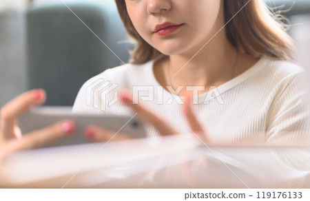 Woman using a smartphone Woman using a smartphone 119176133