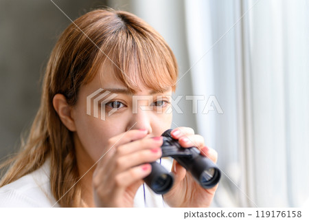 A woman with binoculars 119176158