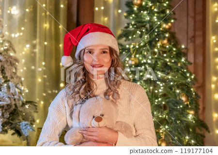 Woman Christmas Holiday Decorated Room Holding Teddy Bear Smiling Woman Christmas Holiday Decorated Room Holding Teddy Bear Smiling 119177104