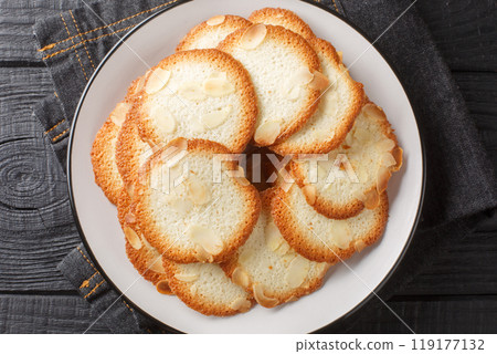French delicacy pastry tuile with almond closeup on the plate. Horizontal top view 119177132