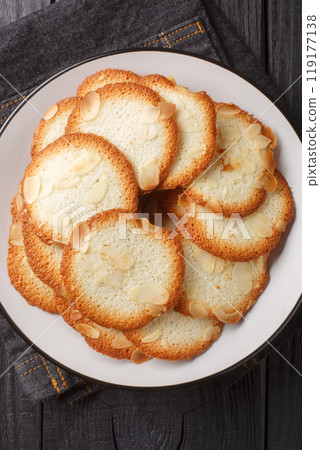 Almond tuiles A Crispy and Fragrant French cookie closeup on the plate. Vertical top view 119177138