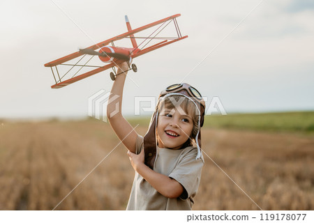 Curious 5 Years Old Preschool Child Boy Plays Craft Wooden Retro Styled Airplane Curious 5 Years Old Preschool Child Boy Plays Craft Wooden Retro Styled Airplane 119178077