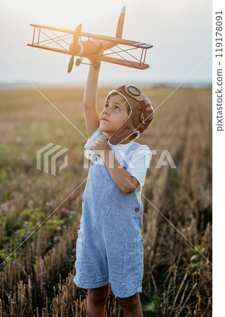 Curious 5 Years Old Preschool Child Boy Plays Craft Wooden Retro Styled Airplane 119178091