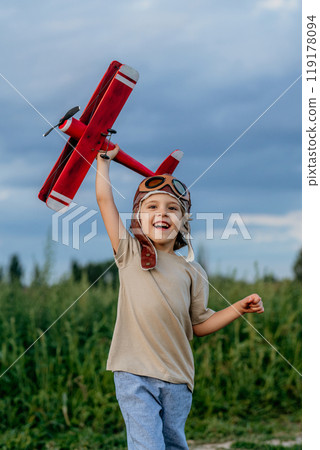 Curious 5 Years Old Preschool Child Boy Plays Craft Wooden Retro Styled Airplane Curious 5 Years Old Preschool Child Boy Plays Craft Wooden Retro Styled Airplane 119178094