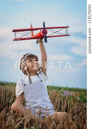 Smiling interested 5 years old child boy playing with wooden airplane. Childhood Smiling interested 5 years old child boy playing with wooden airplane. Childhood 119178095