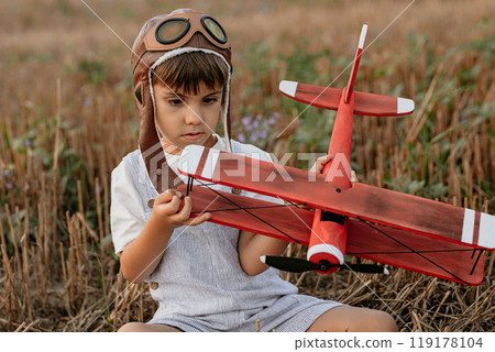 Curious 5 Years Old Preschool Child Boy Plays Craft Wooden Retro Styled Airplane Curious 5 Years Old Preschool Child Boy Plays Craft Wooden Retro Styled Airplane 119178104