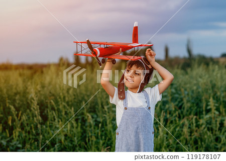 Curious 5 Years Old Preschool Child Boy Plays Craft Wooden Retro Styled Airplane 119178107