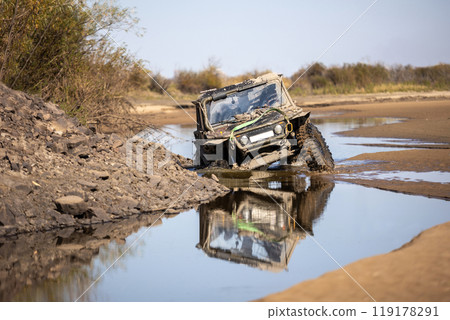 Off road buggy crossing water obstacle 119178291