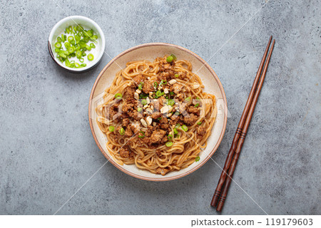 Dan dan noodles served with chopsticks and green onions top view, traditional Chinese Sichuan dish 119179603