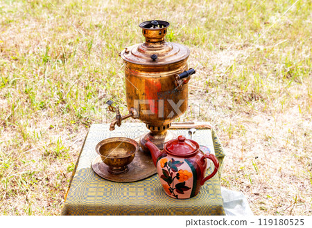 Old Russian traditional samovar for tea ceremony. Retro soot grunge tea samovar was used for a long time 119180525