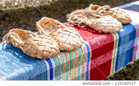 Wicker bast shoes  on the vintage homespun doormat 119180527