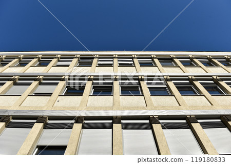 Facade of modern building against blue sky Facade of modern building against blue sky 119180833