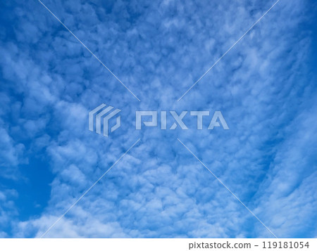 There are patches of small white clouds in the blue sky. A bright sunny summer day There are patches of small white clouds in the blue sky. A bright sunny summer day 119181054