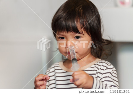 toddler girl washing nasal with syringe and saline by herself. cleaning baby nose toddler girl washing nasal with syringe and saline by herself. cleaning baby nose 119181261