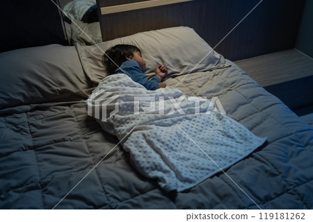 toddler baby sleeping on bed at night 119181262