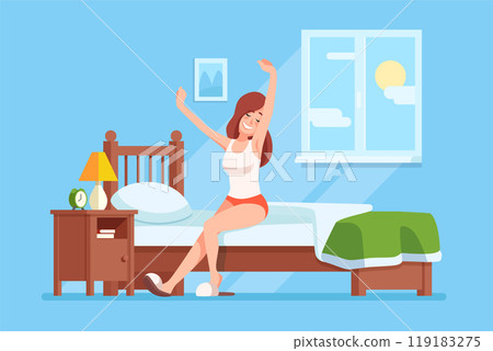 A young woman stretches happily while waking up in a colorful bedroom with sunlight streaming through the window 119183275