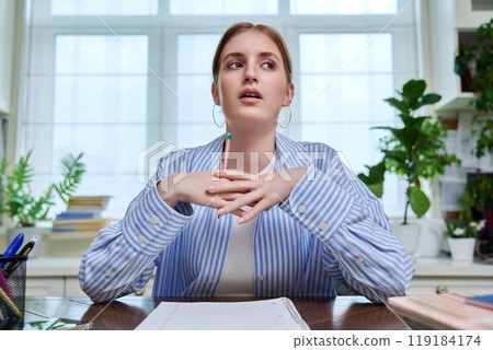 Webcam portrait of teenage female student, sitting at home at desk Webcam portrait of teenage female student, sitting at home at desk 119184174